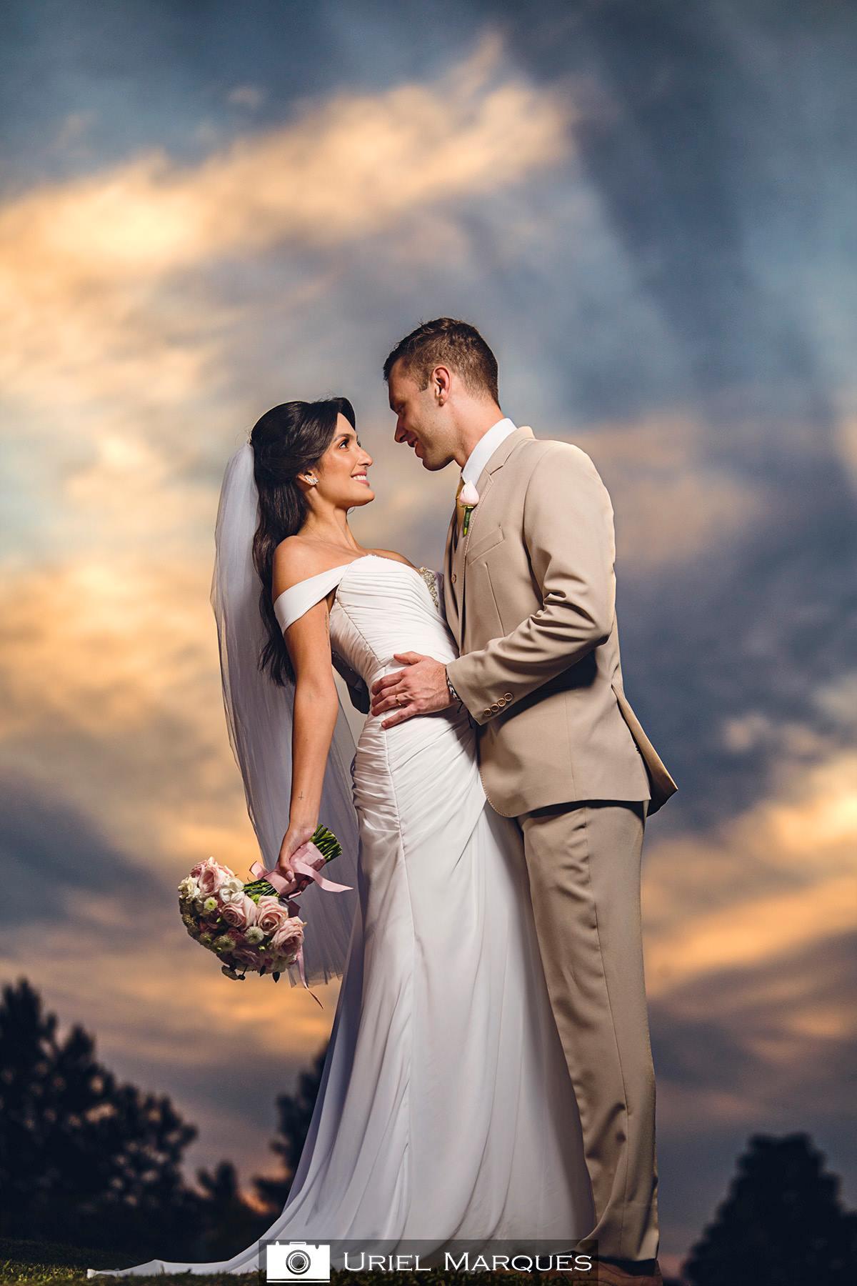 Casal com traje de casamento na praia