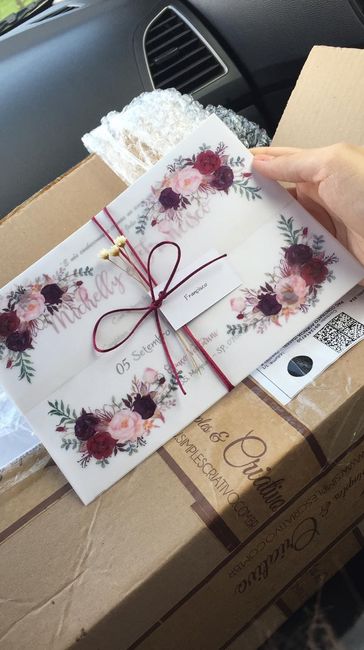 Esse é meu convite vem 3 raminhos de flores neles o papel é branco com a escrita marsala e o envelop