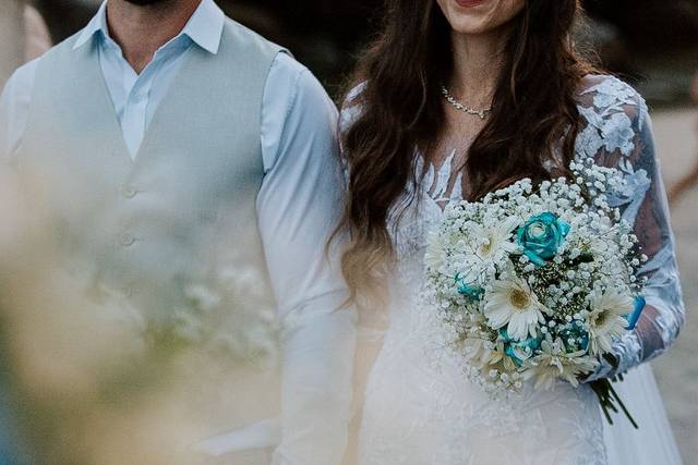 Detalhe do buquê da noiva com flores brancas e azuis em fotografia artística de casamento