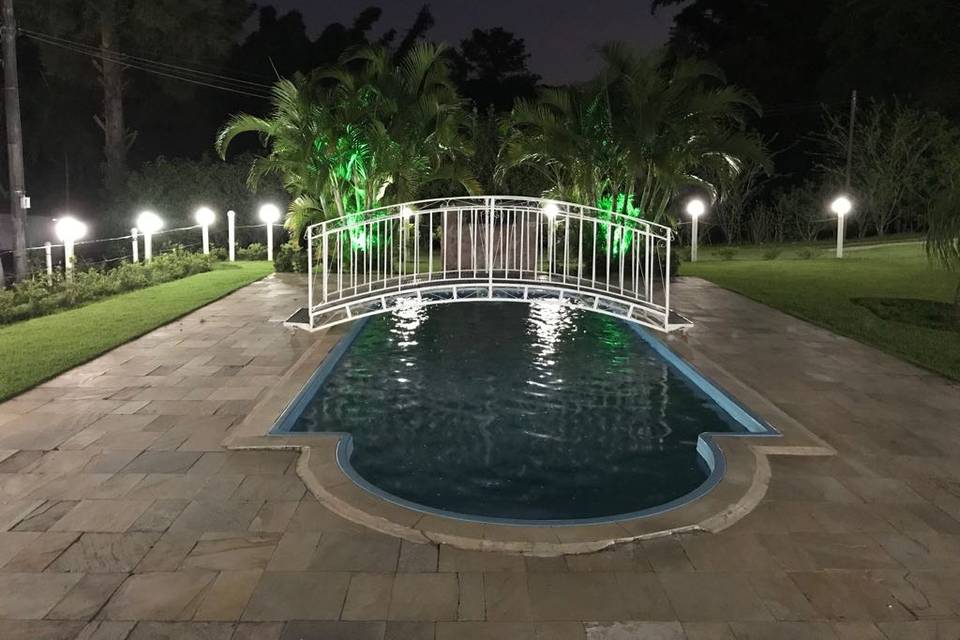 Piscina com ponte iluminada